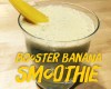 presentation du booster banana smoothie dans un verre avec un morceau de mangue en décoration